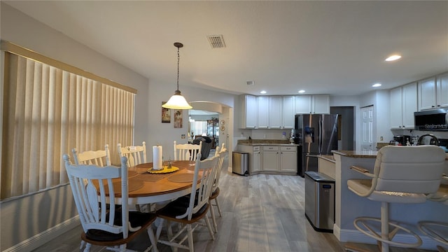 dining space with light wood-type flooring