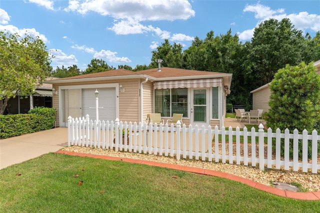 view of front of home featuring a garage and a front lawn