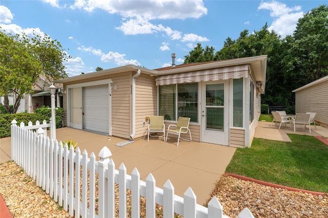 rear view of property featuring a yard and a patio