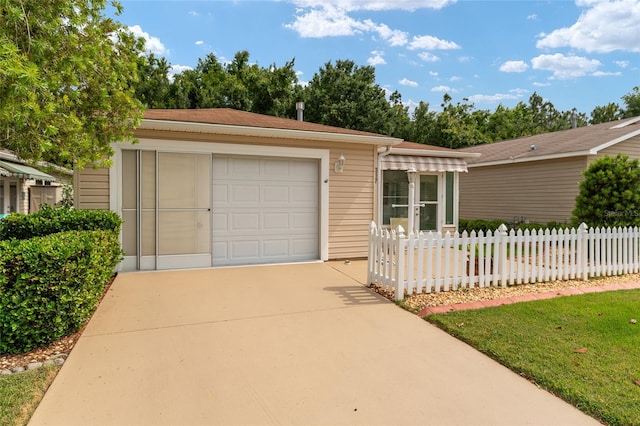 ranch-style home featuring a garage, an outdoor structure, and a front lawn