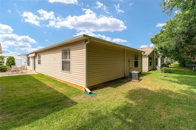 view of home's exterior with a patio and a lawn