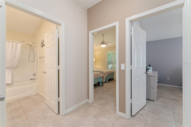 bathroom with tile patterned floors, bathtub / shower combination, a textured ceiling, and vanity