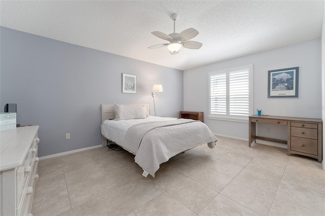 tiled bedroom featuring a textured ceiling and ceiling fan