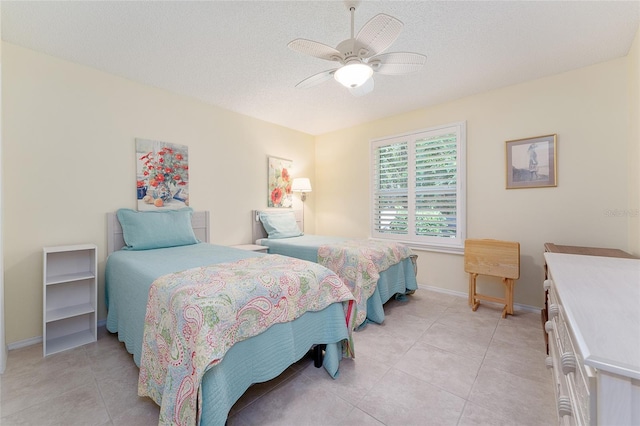 bedroom featuring light tile patterned flooring, a textured ceiling, and ceiling fan