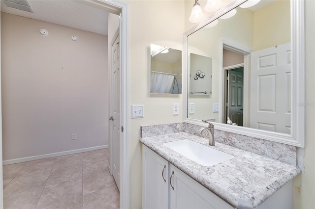 bathroom with tile patterned flooring and vanity