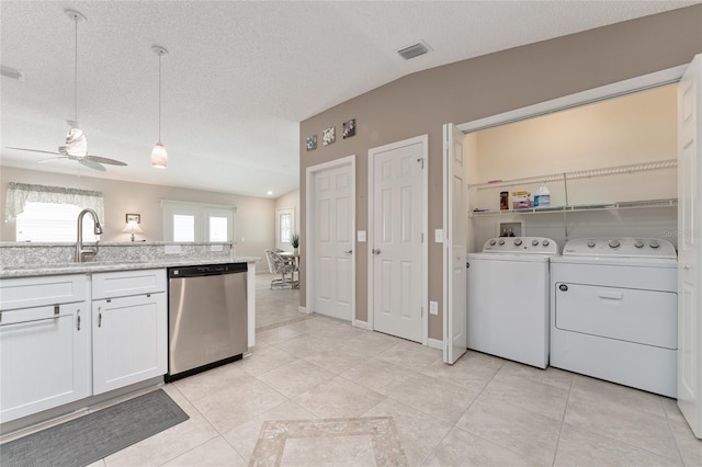 kitchen with white cabinetry, lofted ceiling, sink, and stainless steel dishwasher