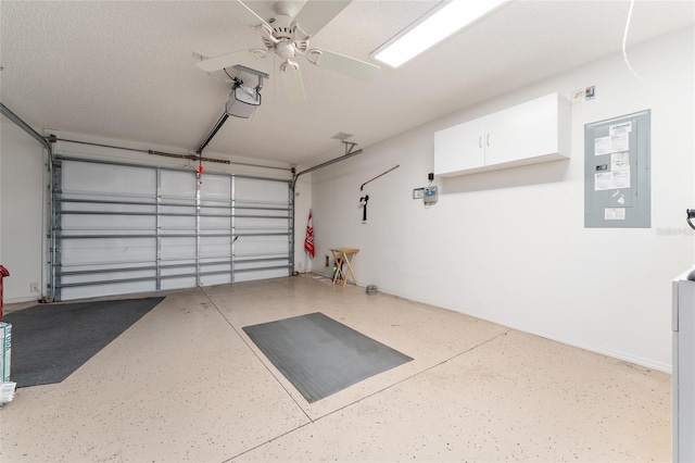 garage with a garage door opener, electric panel, and ceiling fan