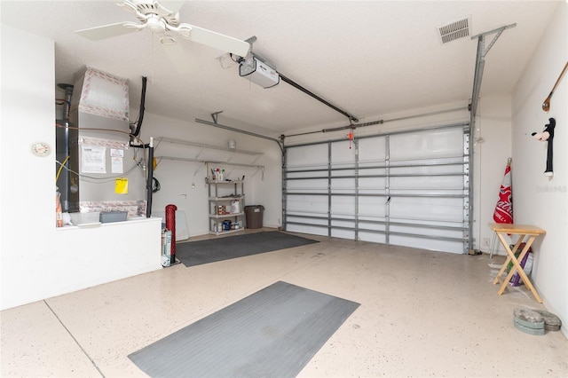 garage with ceiling fan, a garage door opener, and heating unit