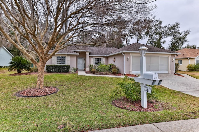 ranch-style home with a garage and a front lawn