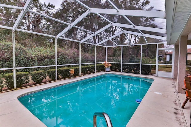 view of swimming pool with a lanai and a patio area