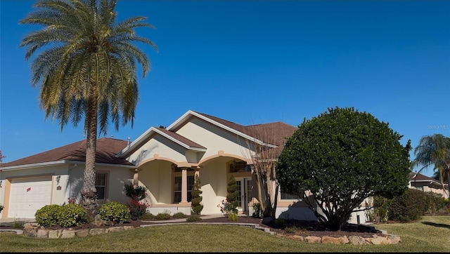 ranch-style home featuring a garage and a front yard