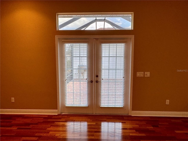 entryway featuring french doors, wood-type flooring, and a wealth of natural light