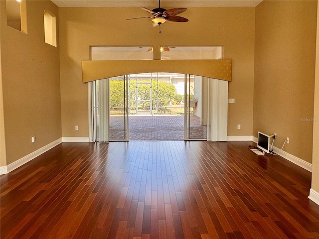 spare room with dark hardwood / wood-style floors and ceiling fan