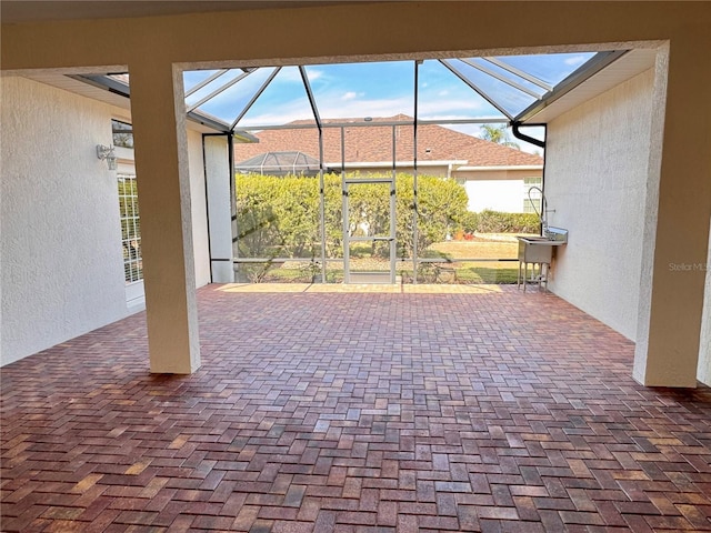 view of patio / terrace featuring glass enclosure