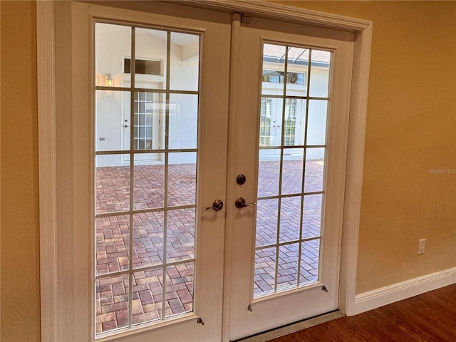 doorway to outside with french doors and wood-type flooring