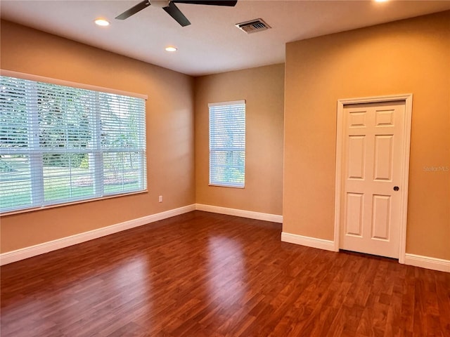 spare room featuring dark hardwood / wood-style floors and ceiling fan