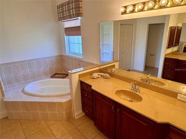 bathroom with vanity, tile patterned floors, and tiled bath