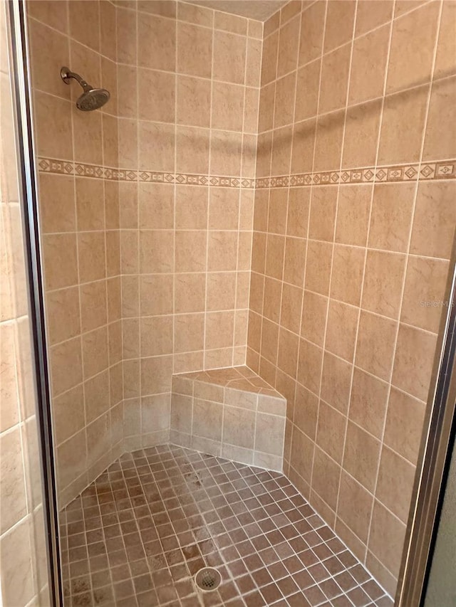 bathroom with tiled shower