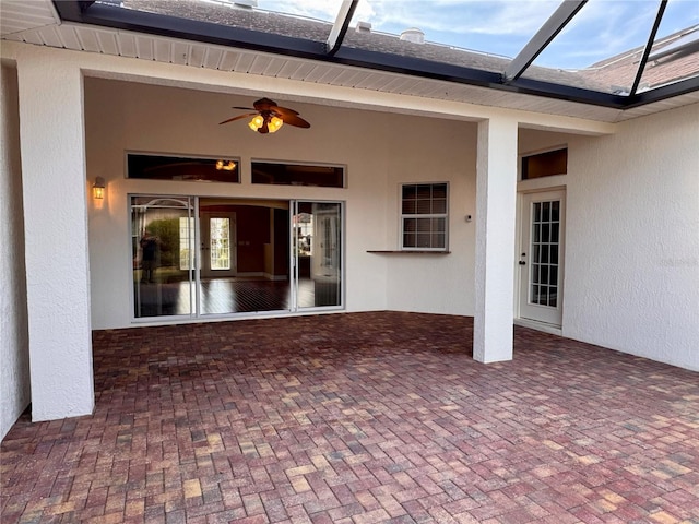 exterior space with ceiling fan and glass enclosure