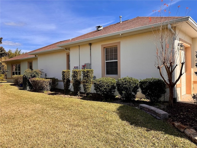 view of side of property with a lawn