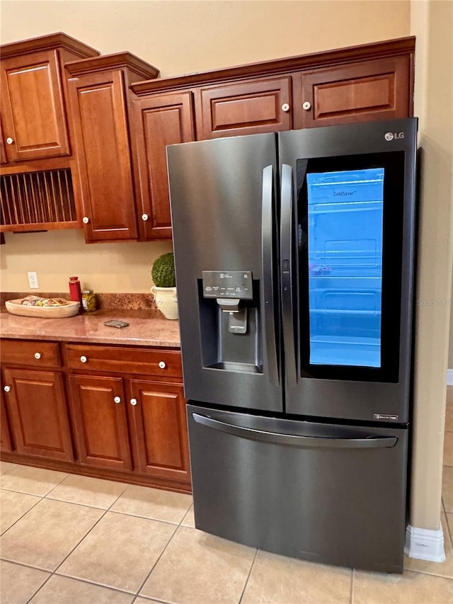 kitchen featuring light tile patterned floors and stainless steel fridge with ice dispenser