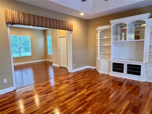 unfurnished living room with baseboards, recessed lighting, and wood finished floors
