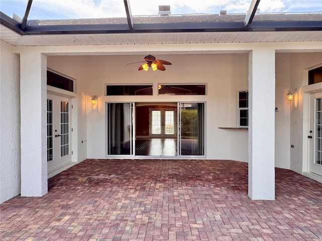 view of patio with a lanai, french doors, and a ceiling fan