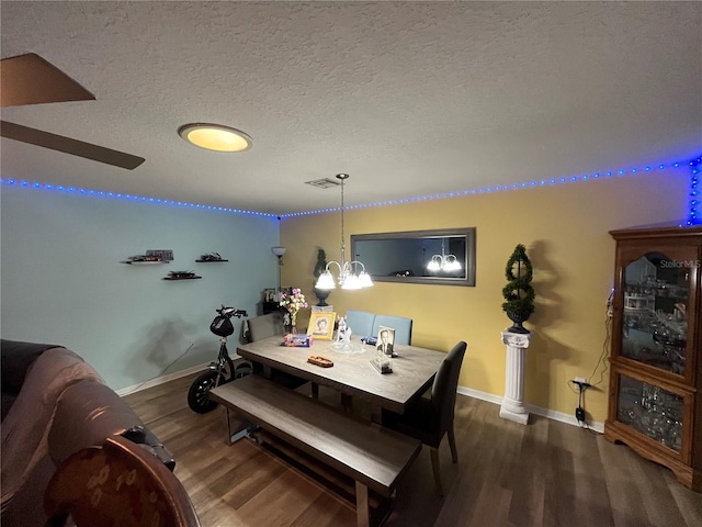 dining area featuring dark hardwood / wood-style floors and a textured ceiling