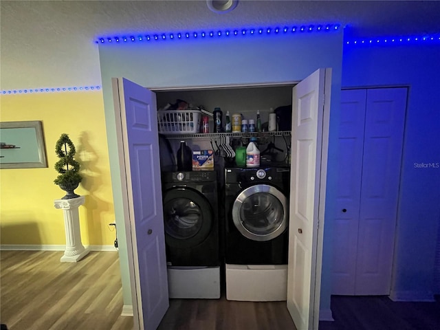 clothes washing area featuring hardwood / wood-style flooring and separate washer and dryer