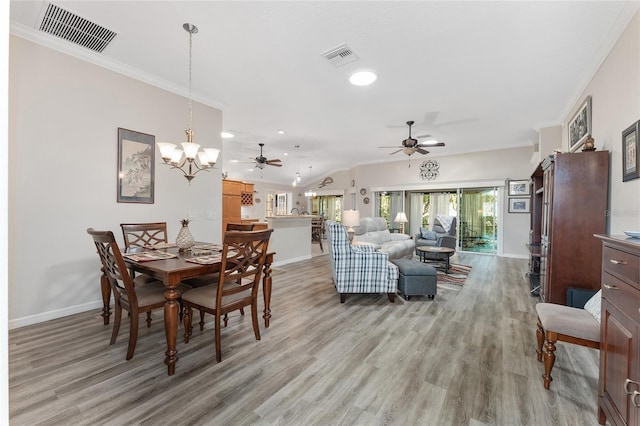 dining room with crown molding, ceiling fan with notable chandelier, and light hardwood / wood-style floors