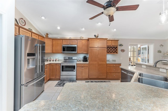 kitchen featuring sink, crown molding, light tile patterned floors, appliances with stainless steel finishes, and hanging light fixtures