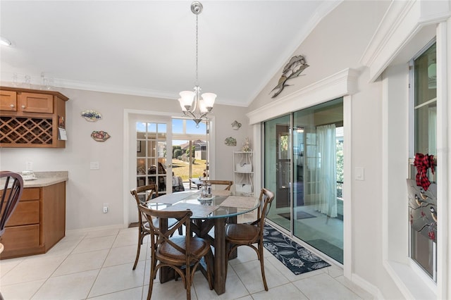 tiled dining room with crown molding, bar, lofted ceiling, and a chandelier