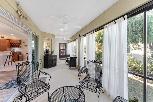 sunroom with a wealth of natural light and ceiling fan