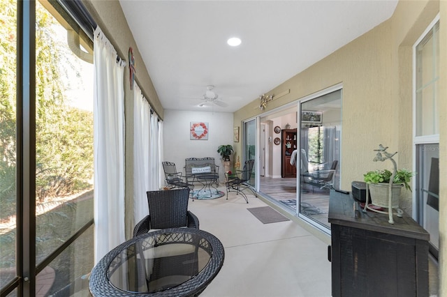 sunroom featuring ceiling fan