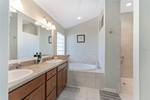 bathroom featuring tile patterned floors, shower with separate bathtub, vaulted ceiling, and vanity