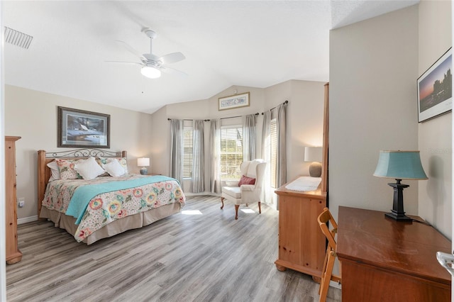 bedroom with vaulted ceiling, ceiling fan, and light hardwood / wood-style floors