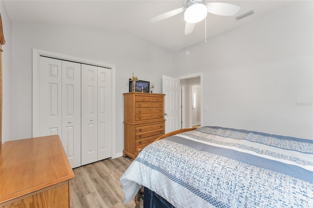 bedroom with ceiling fan, lofted ceiling, a closet, and light hardwood / wood-style flooring