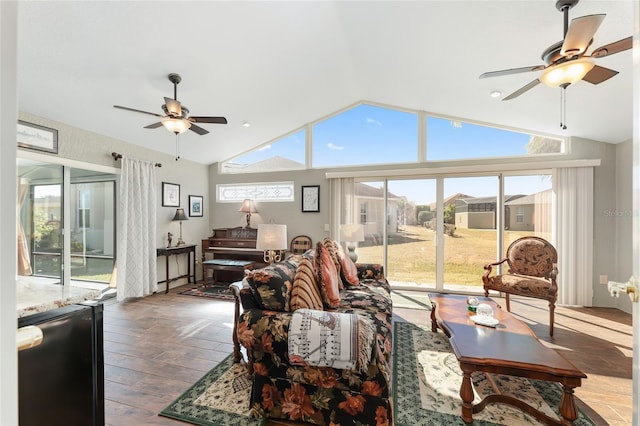 living room featuring hardwood / wood-style flooring, vaulted ceiling, and ceiling fan