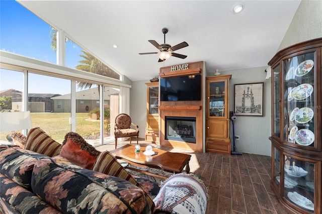 living room with ceiling fan and vaulted ceiling