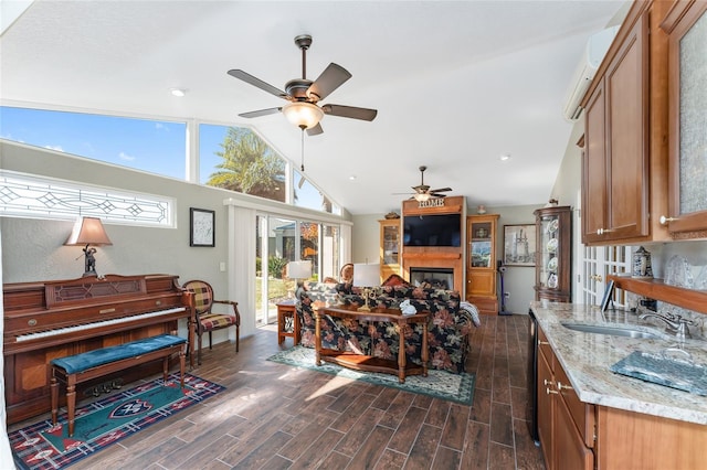 interior space with lofted ceiling, sink, and ceiling fan