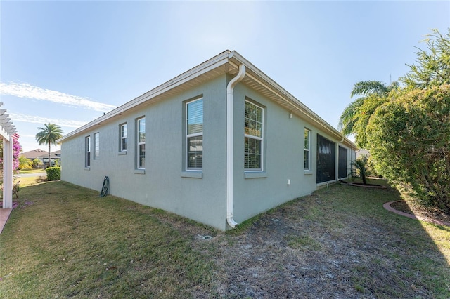 view of side of property with a lawn