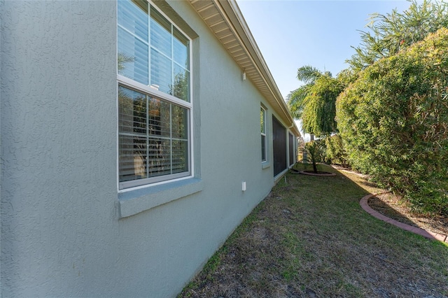 view of side of home featuring a yard