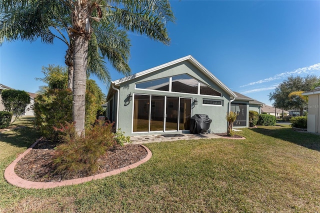 back of house with a lawn