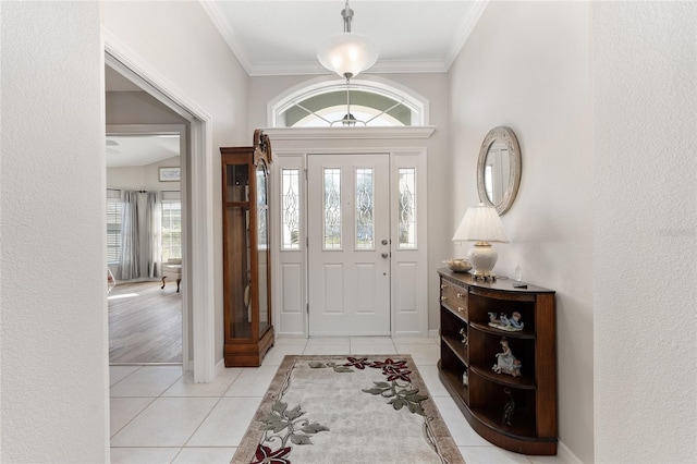 tiled foyer entrance with ornamental molding