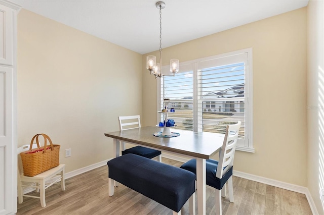 dining area with a notable chandelier and light wood-type flooring