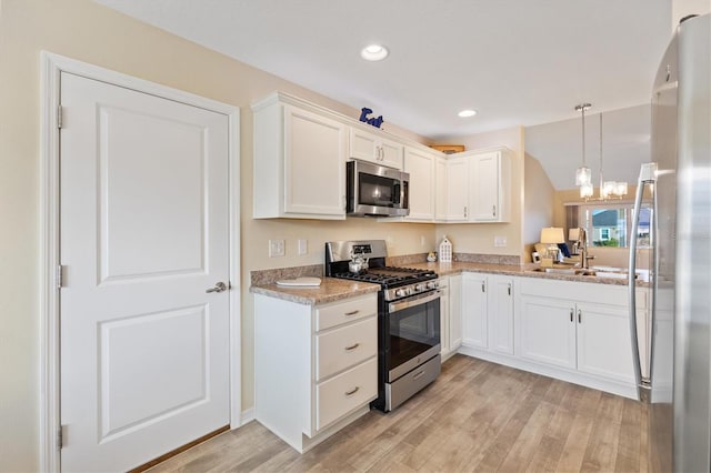 kitchen featuring white cabinetry, appliances with stainless steel finishes, and sink