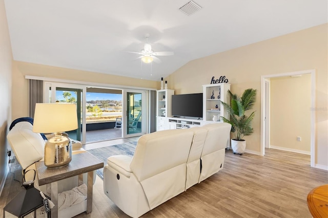 living room featuring lofted ceiling, ceiling fan, and light wood-type flooring