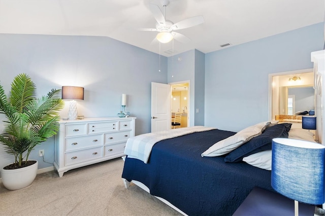 bedroom with light carpet, lofted ceiling, ceiling fan, and ensuite bathroom