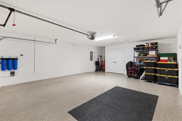 garage featuring a garage door opener and electric panel