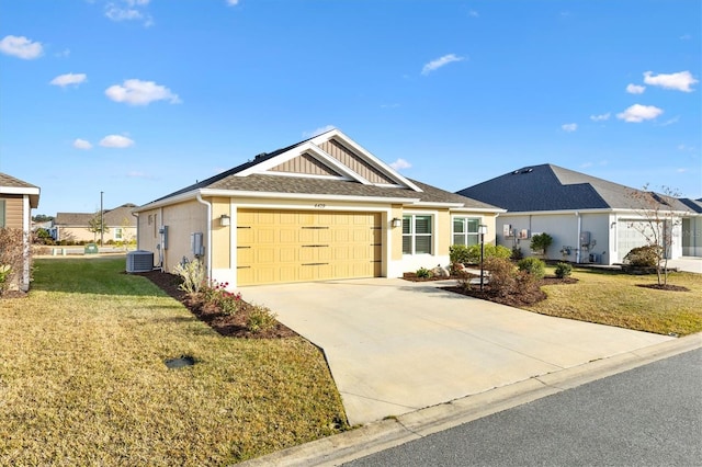 ranch-style home featuring a garage, central AC unit, and a front lawn